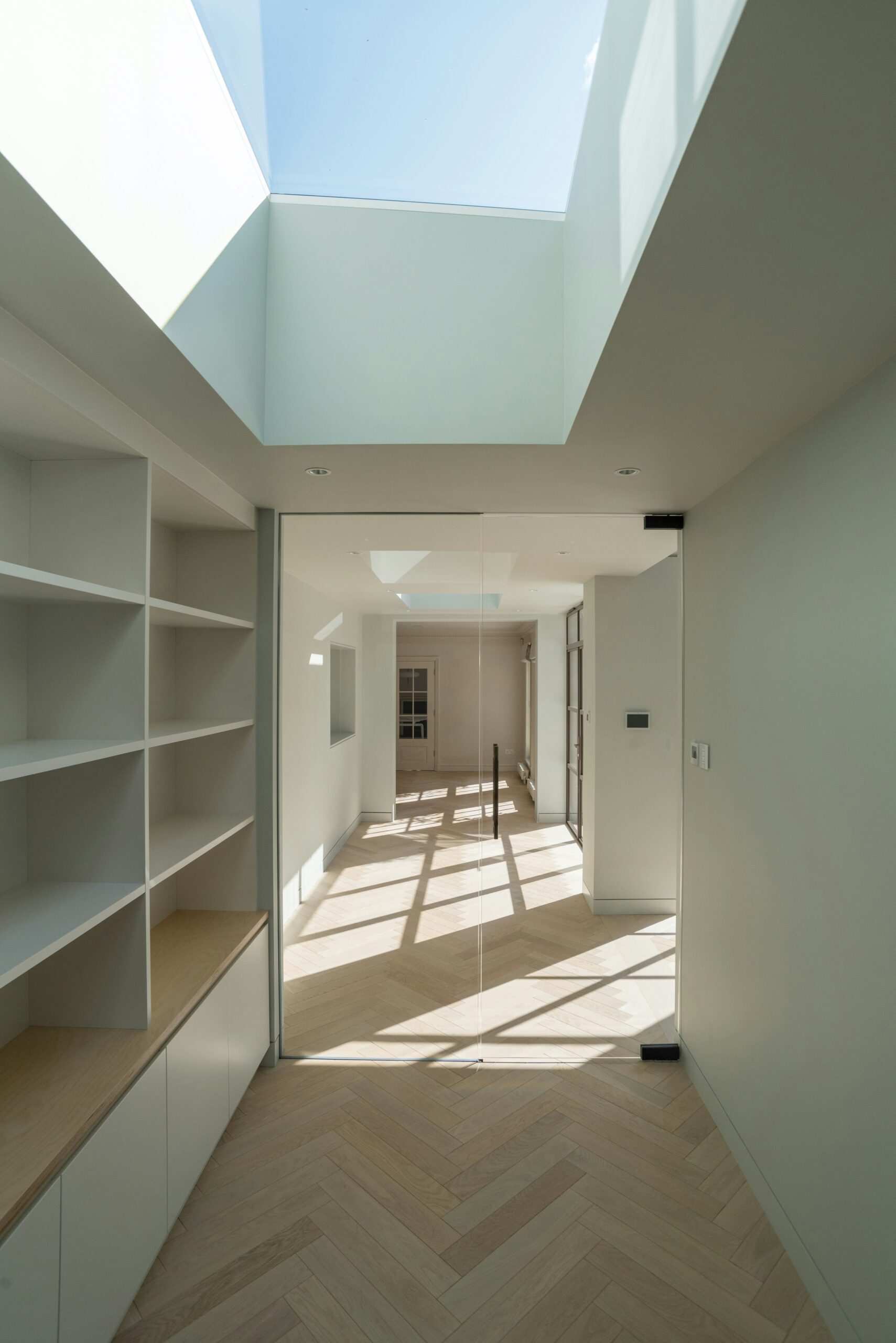 Modern finished basement with exposed brick wall and recessed lighting.