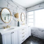 Luxurious bathroom remodel featuring large format marble tiles and a large wall tile