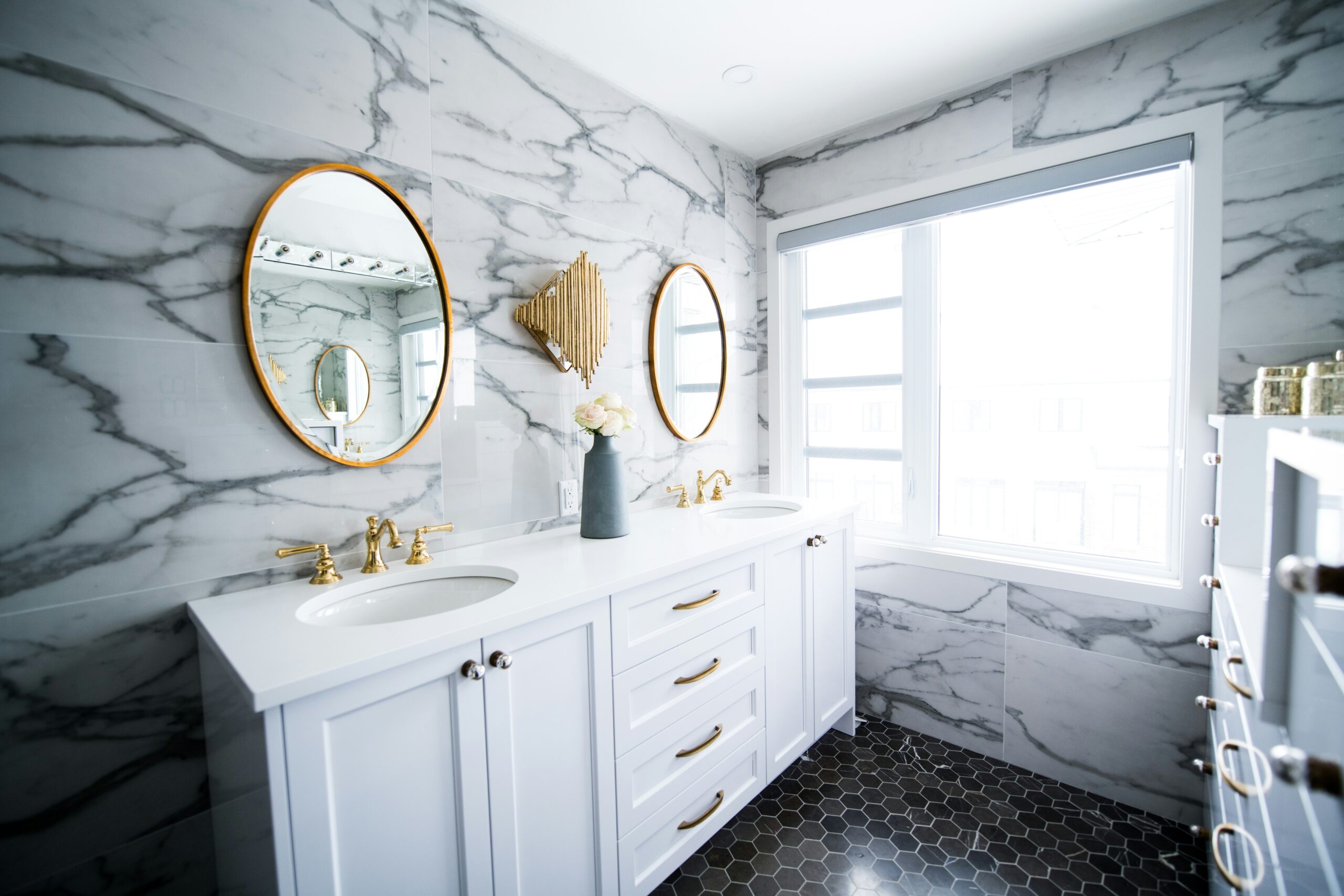 Luxurious bathroom remodel featuring large format marble tiles and a large wall tile