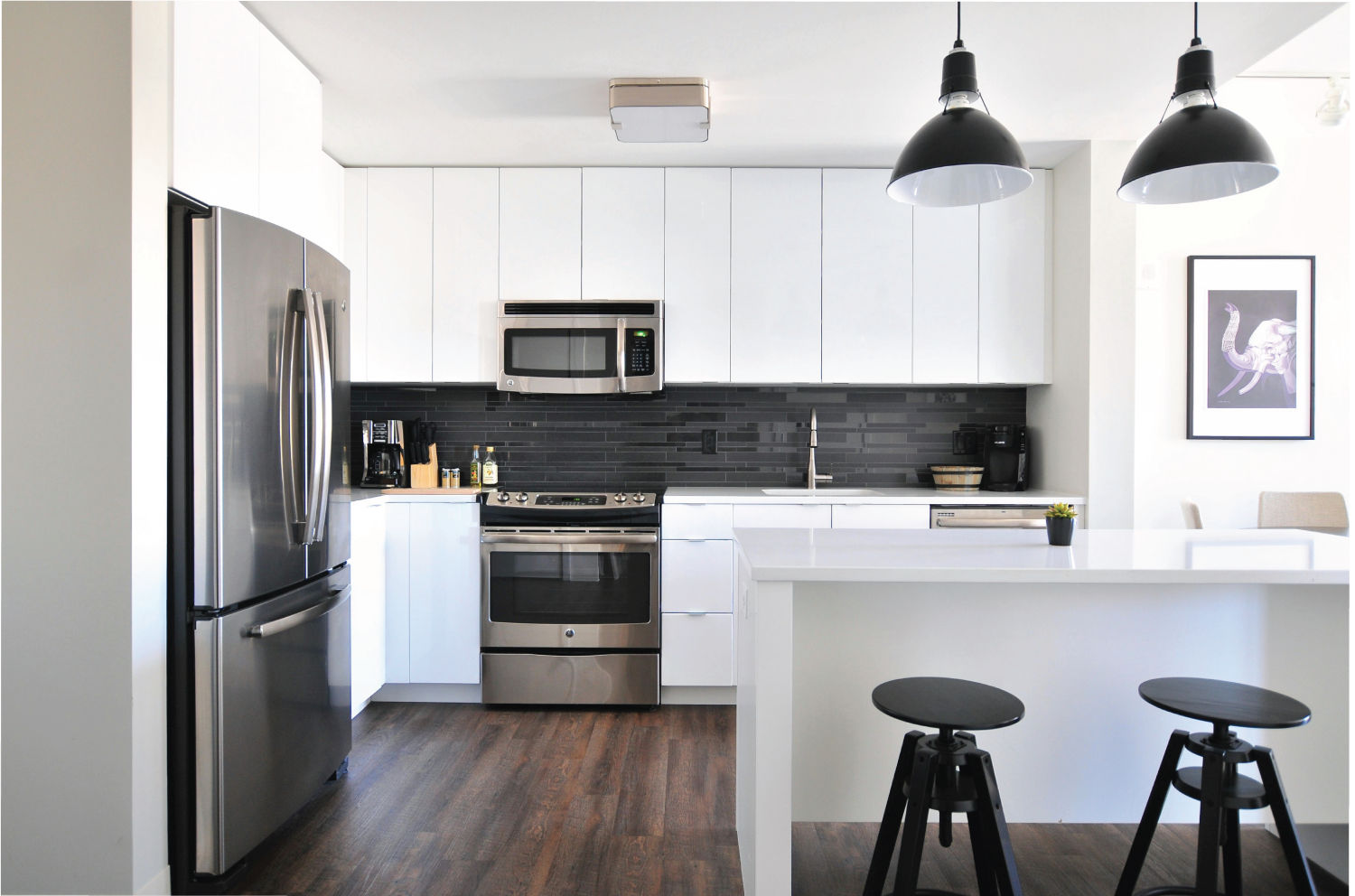 Modern kitchen remodel featuring sleek pendant lights over a breakfast bar.