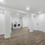 Basement finishing project showcasing modern design with built-in shelving and comfortable seating area