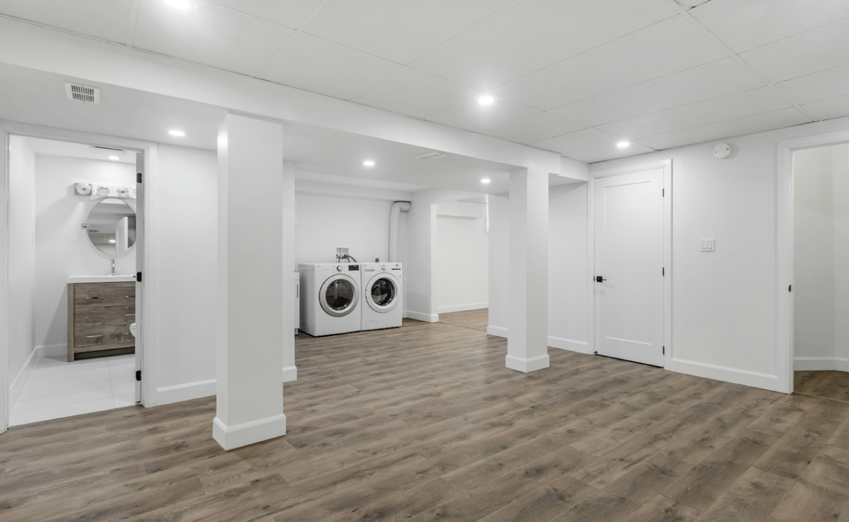 Basement finishing project showcasing modern design with built-in shelving and comfortable seating area