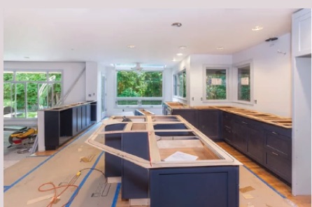 Kitchen remodel featuring modern white cabinets with sleek hardware and open shelving