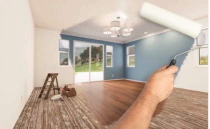 Handyman painting the interior of a residential home with a roller